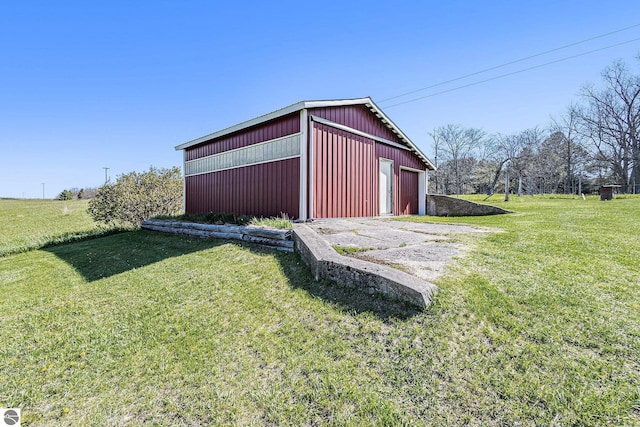 view of pole building featuring a yard and driveway