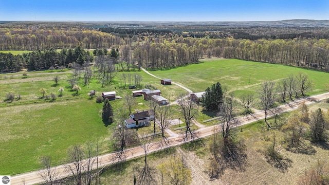 aerial view of property and surrounding area featuring a forest and rural landscape