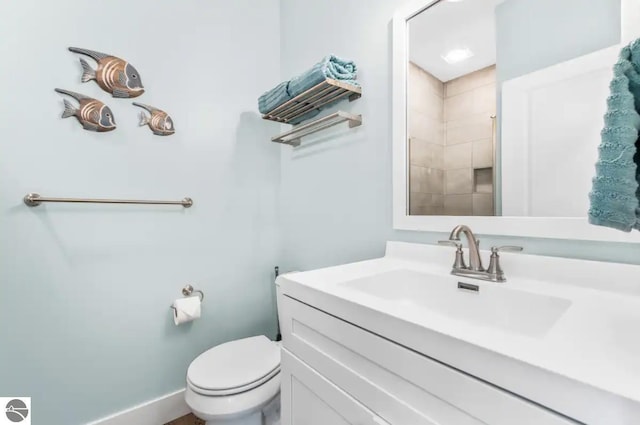 914 E Front St Unit 16, Traverse City, MI 49686 - full bath with toilet, vanity, tiled shower, and baseboards