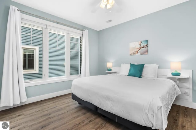 914 E Front St Unit 16, Traverse City, MI 49686 - bedroom with baseboards, wood finished floors, and ceiling fan