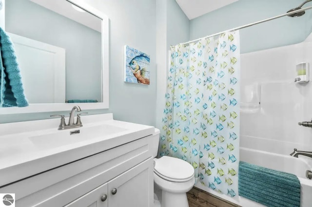 914 E Front St Unit 16, Traverse City, MI 49686 - full bath with toilet, wood finished floors, vanity, and shower / tub combo with curtain