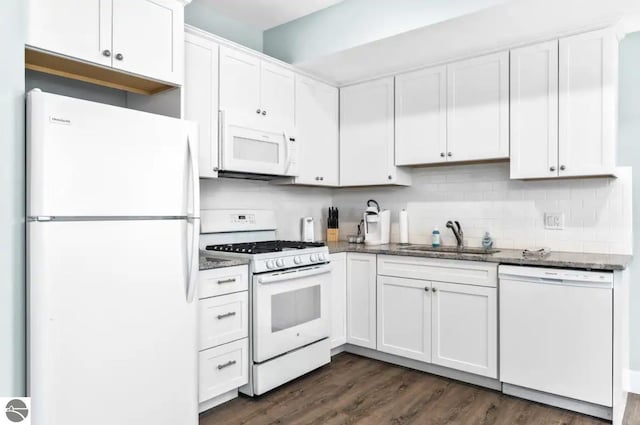 914 E Front St Unit 16, Traverse City, MI 49686 - kitchen featuring white appliances, a sink, white cabinetry, dark wood-style flooring, and dark stone counters