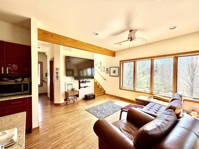 living area featuring stairway, light wood-style flooring, recessed lighting, baseboards, and a ceiling fan