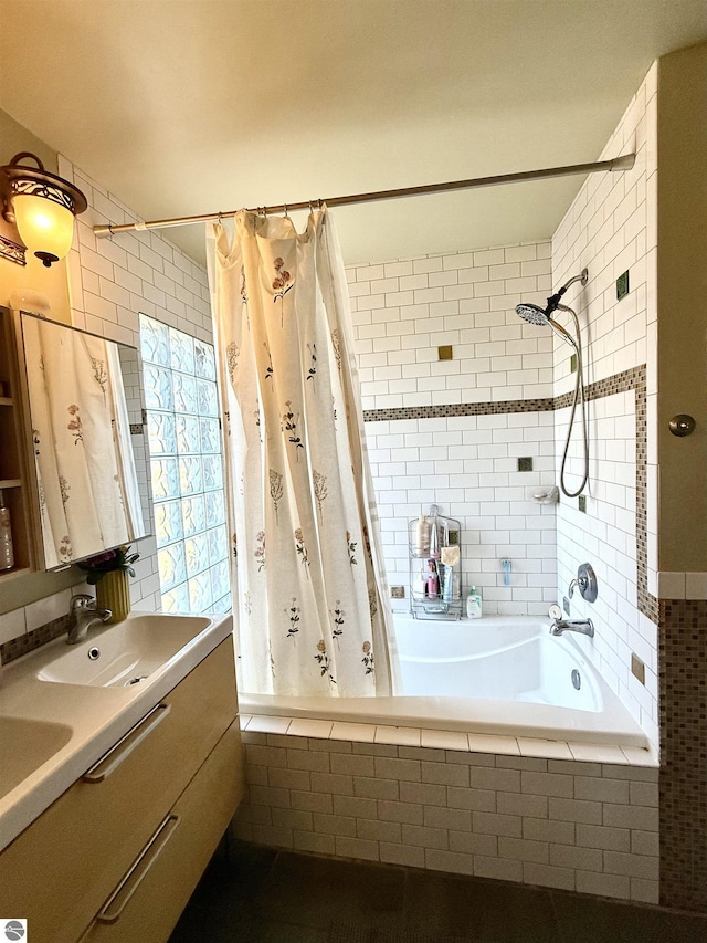 full bath with tiled shower / bath combo and double vanity