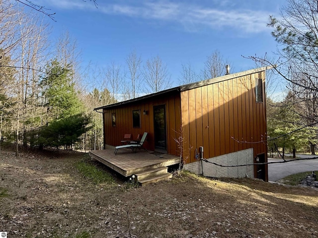 rear view of property with a wooden deck