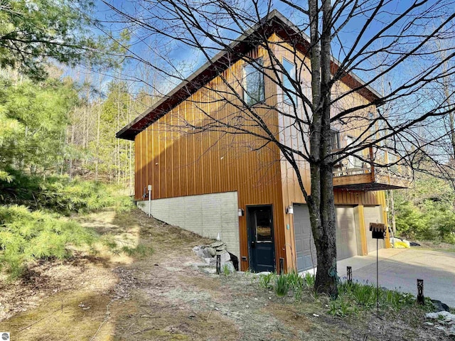 view of property exterior featuring driveway and a garage