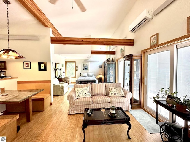 living room with a wall unit AC, a ceiling fan, light wood-type flooring, beamed ceiling, and a high ceiling