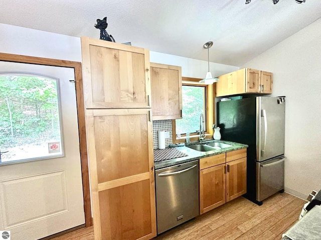10959 E Pobuda Rd, Suttons Bay, MI 49682 - kitchen with appliances with stainless steel finishes, light wood-type flooring, decorative light fixtures, light brown cabinets, and lofted ceiling