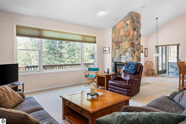 4854 Forest Trl, Bellaire, MI 49615 - carpeted living area with baseboards, high vaulted ceiling, and a stone fireplace