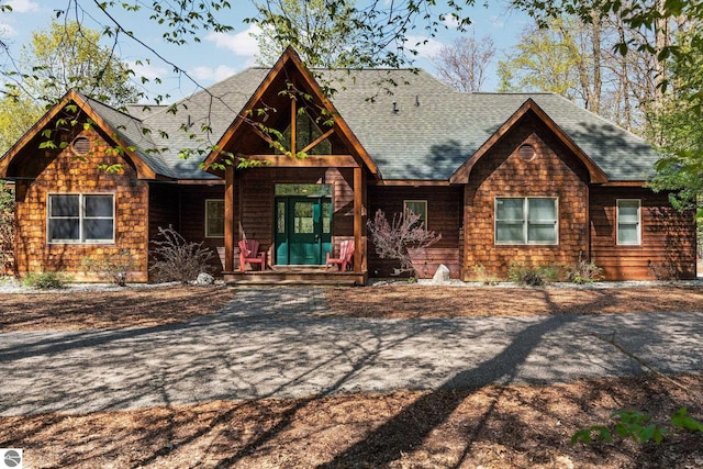 4854 Forest Trl, Bellaire, MI 49615 - view of front facade with covered porch and roof with shingles