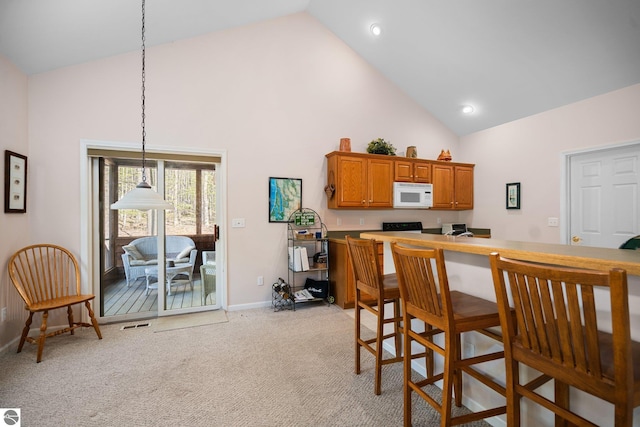 4854 Forest Trl, Bellaire, MI 49615 - dining room with high vaulted ceiling, baseboards, light colored carpet, and recessed lighting