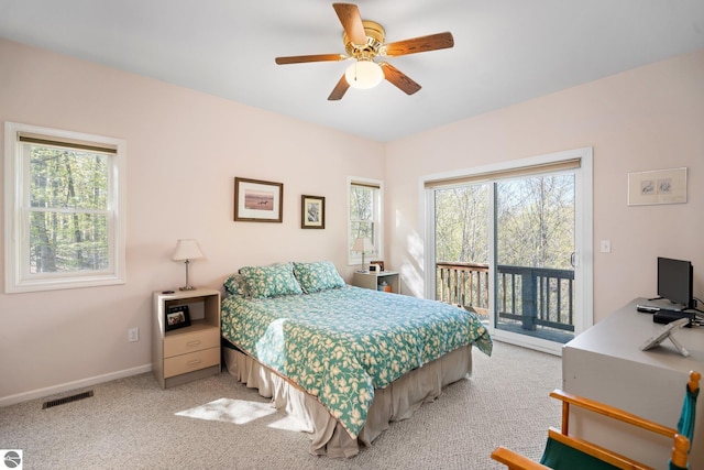 4854 Forest Trl, Bellaire, MI 49615 - bedroom featuring access to exterior, baseboards, light colored carpet, and a ceiling fan