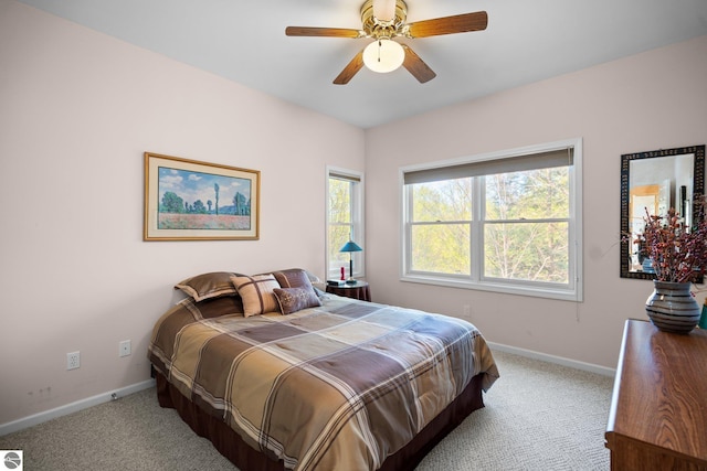 4854 Forest Trl, Bellaire, MI 49615 - bedroom featuring light carpet, baseboards, and ceiling fan