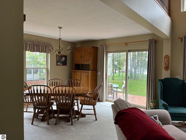 6557 Betsie River Rd, Interlochen, MI 49643 - dining area with a chandelier, healthy amount of natural light, and light colored carpet