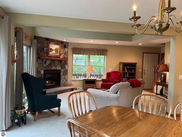 6557 Betsie River Rd, Interlochen, MI 49643 - dining room featuring light carpet, a stone fireplace, and recessed lighting