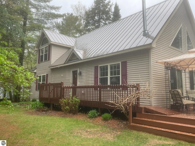6557 Betsie River Rd, Interlochen, MI 49643 - back of property with a deck, metal roof, a yard, and a gazebo