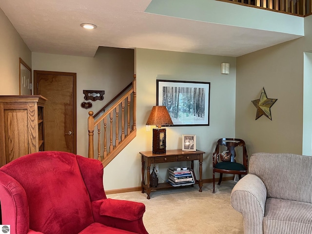 6557 Betsie River Rd, Interlochen, MI 49643 - sitting room featuring carpet floors, stairway, baseboards, and recessed lighting