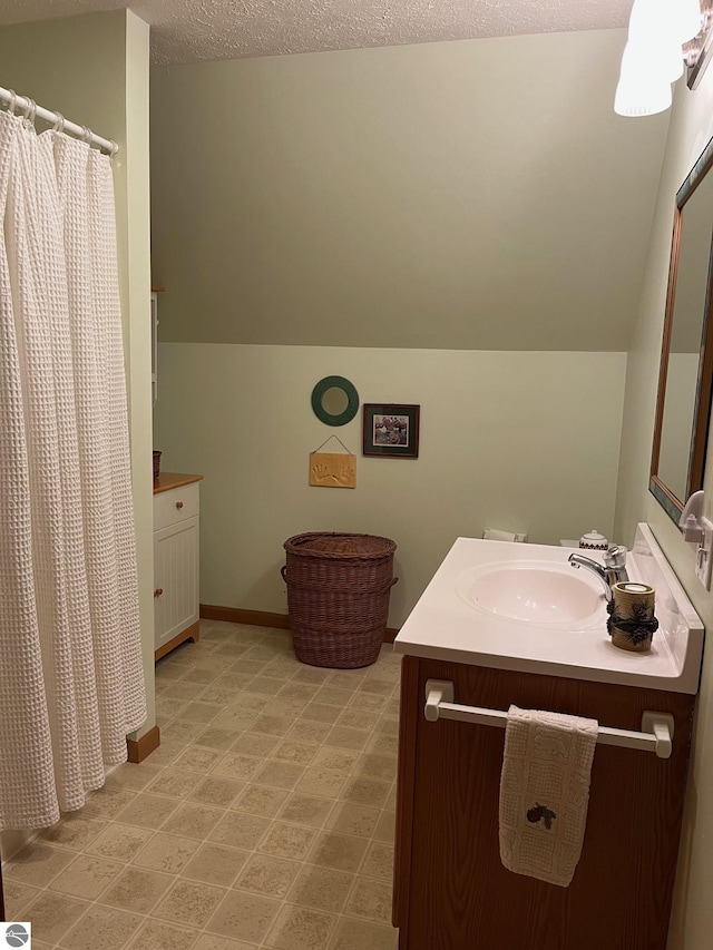 6557 Betsie River Rd, Interlochen, MI 49643 - full bath featuring vanity, a textured ceiling, curtained shower, and vaulted ceiling