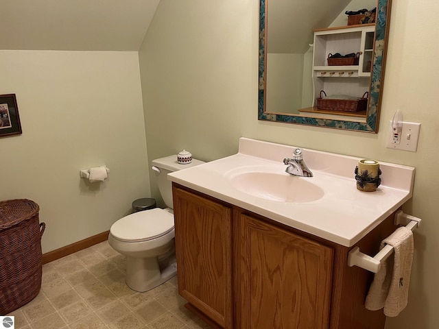 6557 Betsie River Rd, Interlochen, MI 49643 - bathroom with toilet, vanity, baseboards, and lofted ceiling
