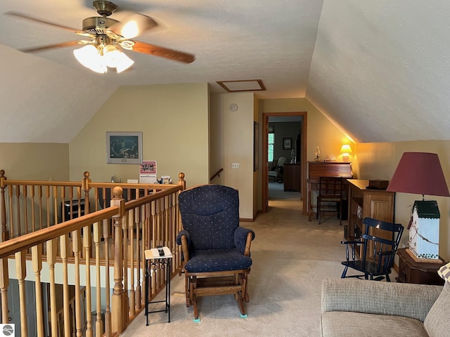 6557 Betsie River Rd, Interlochen, MI 49643 - sitting room featuring carpet, vaulted ceiling, an upstairs landing, and ceiling fan