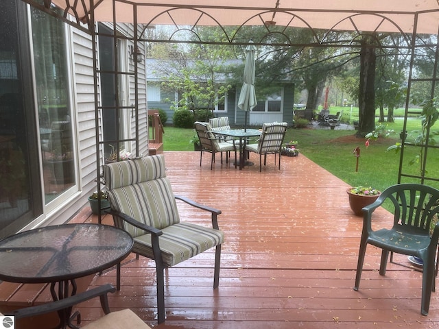 6557 Betsie River Rd, Interlochen, MI 49643 - deck featuring outdoor dining space and a yard
