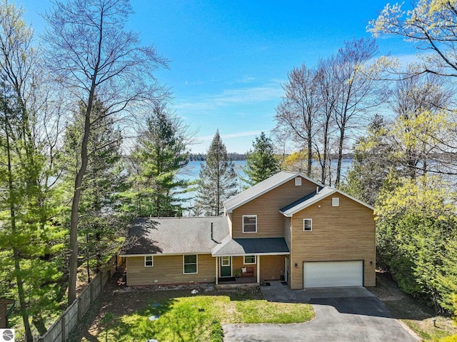 4306 Central Park Dr, Grawn, MI 49637 - traditional-style home featuring driveway and an attached garage