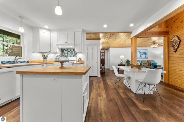 4306 Central Park Dr, Grawn, MI 49637 - kitchen with butcher block countertops, a kitchen island, under cabinet range hood, white cabinetry, and recessed lighting
