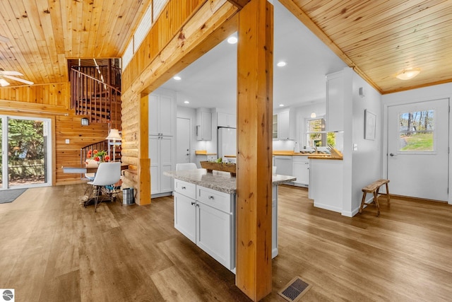 4306 Central Park Dr, Grawn, MI 49637 - kitchen with wood finished floors, white cabinetry, wooden ceiling, recessed lighting, and baseboards