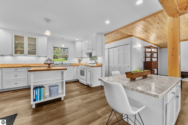4306 Central Park Dr, Grawn, MI 49637 - kitchen with white gas range, a center island, butcher block countertops, white cabinets, and recessed lighting