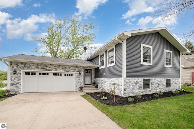 1254 Queensway Dr, Lake Isabella, MI 48893 - tri-level home featuring driveway, a chimney, a front yard, an attached garage, and stone siding