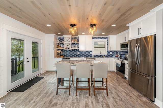 1254 Queensway Dr, Lake Isabella, MI 48893 - kitchen with appliances with stainless steel finishes, open shelves, a center island, a sink, and white cabinets