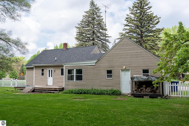 1618 E High, Mount Pleasant, MI 48858 - back of property with a wooden deck, a chimney, and a shingled roof