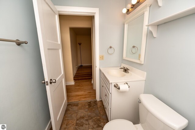 1618 E High, Mount Pleasant, MI 48858 - bathroom with stone finish flooring, toilet, and vanity