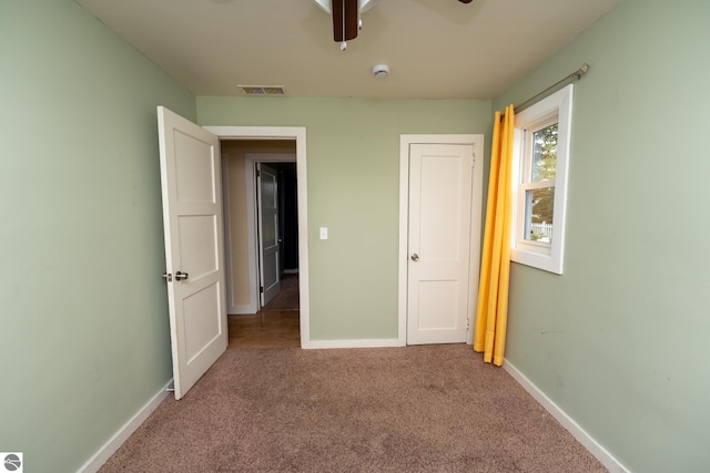 1618 E High, Mount Pleasant, MI 48858 - unfurnished bedroom with carpet floors, baseboards, and a ceiling fan