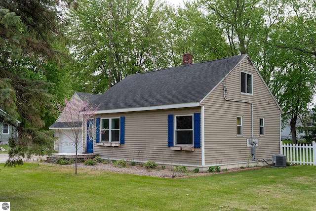 1618 E High, Mount Pleasant, MI 48858 - view of side of property featuring central air condition unit, a chimney, an attached garage, and roof with shingles