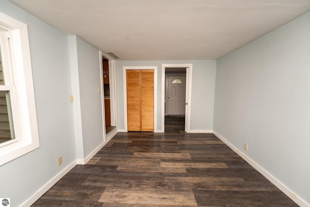 1618 E High, Mount Pleasant, MI 48858 - unfurnished bedroom with dark wood-style flooring and baseboards