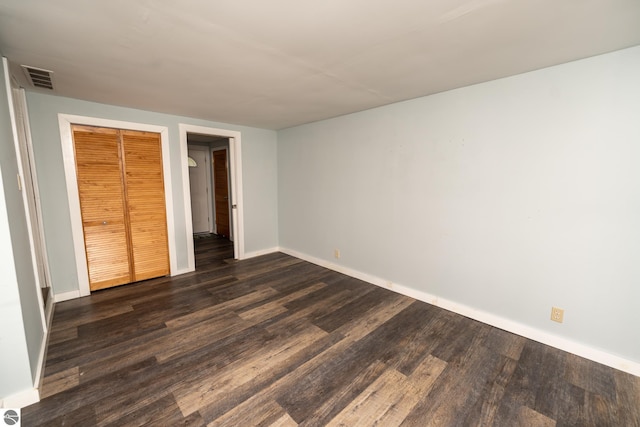1618 E High, Mount Pleasant, MI 48858 - unfurnished bedroom with baseboards, dark wood finished floors, and a closet