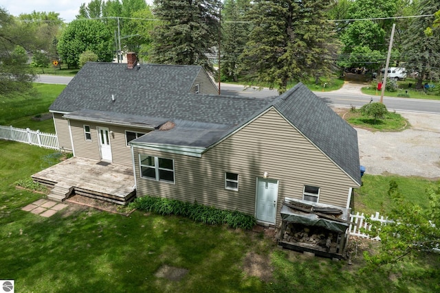 1618 E High, Mount Pleasant, MI 48858 - rear view of property featuring roof with shingles, a wooden deck, and a chimney