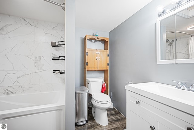 505 S Cherry St, Kalkaska, MI 49646 - bathroom featuring wood finished floors, toilet, vanity, and tub / shower combination