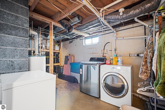 505 S Cherry St, Kalkaska, MI 49646 - basement featuring white fridge, washer and dryer, and water heater