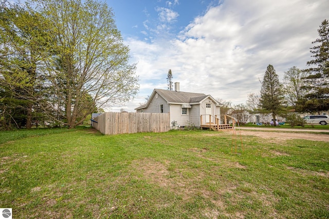 505 S Cherry St, Kalkaska, MI 49646 - view of side of home with a chimney