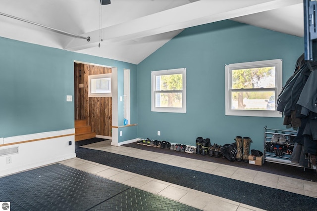 8817 Wilson Rd, Buckley, MI 49620 - workout room with vaulted ceiling, tile patterned floors, inlaid floor details, baseboards, and ceiling fan
