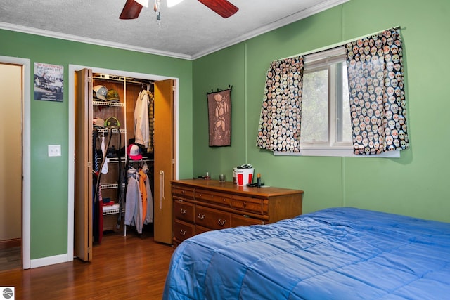 8817 Wilson Rd, Buckley, MI 49620 - bedroom featuring wood finished floors, ornamental molding, a closet, baseboards, and ceiling fan