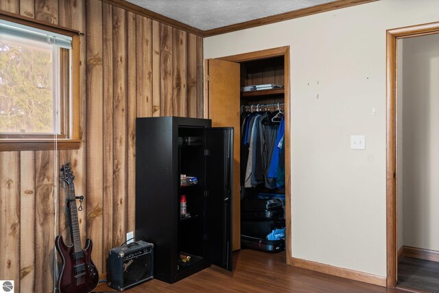 8817 Wilson Rd, Buckley, MI 49620 - kitchen with ornamental molding, wood finished floors, wood walls, and baseboards