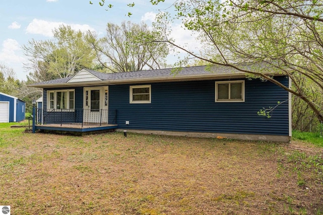 8817 Wilson Rd, Buckley, MI 49620 - ranch-style home featuring a front yard, an outbuilding, and a garage