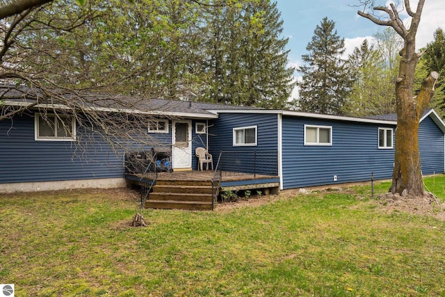 8817 Wilson Rd, Buckley, MI 49620 - rear view of property with a wooden deck and a yard