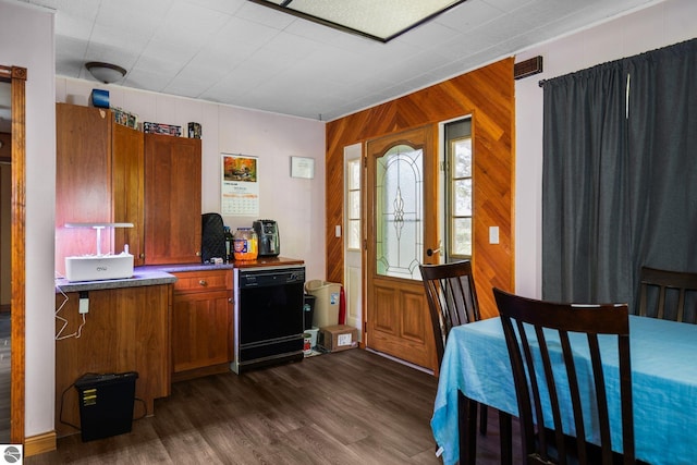 8817 Wilson Rd, Buckley, MI 49620 - kitchen with brown cabinetry, wood walls, dark wood-style floors, dishwasher, and dark countertops