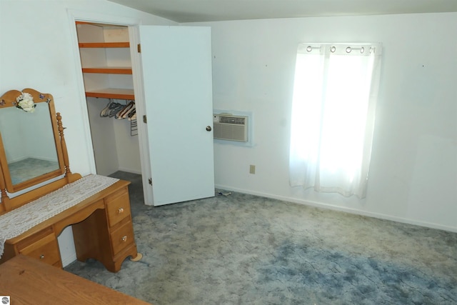 1078 Duquesa Dr, Weidman, MI 48893 - unfurnished bedroom featuring carpet floors, an AC wall unit, baseboards, a closet, and a spacious closet