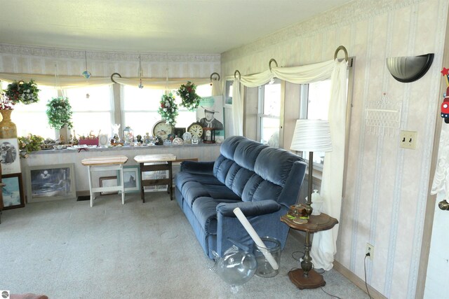 1078 Duquesa Dr, Weidman, MI 48893 - living area featuring healthy amount of natural light, wallpapered walls, and carpet flooring