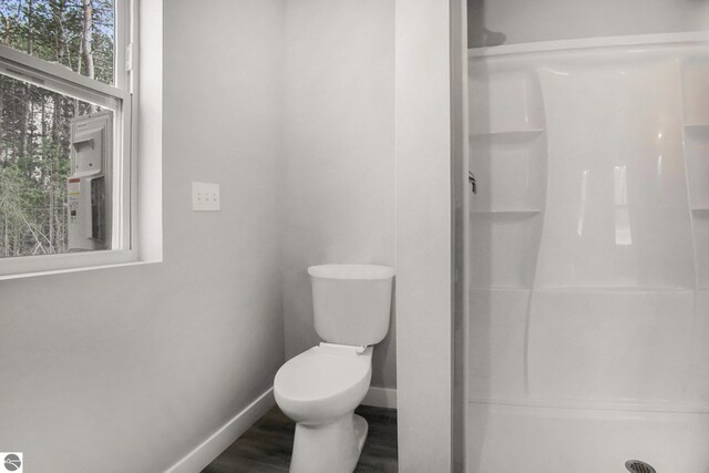 5203 NE Myers Rd, Kalkaska, MI 49646 - full bath with a shower stall, baseboards, wood finished floors, and toilet